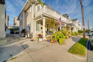 a house with an american flag on a street at Walk to Beach Dog-Friendly Ventnor City Retreat! in Ventnor City