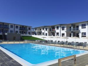 a large swimming pool in front of some buildings at Like at Home in Costa de Antigua