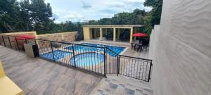 a balcony with a swimming pool in a house at Villa Montilla Cabañas Anapoima in Anapoima