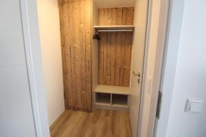 a small room with a closet with wooden walls at Haus Nordseeresidenz Wohnung 63 in Westerland (Sylt)
