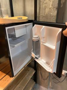 an empty refrigerator with its door open in a kitchen at SUMMER HOUSE B Starlink in General Luna +15 photos