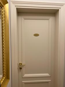 a white door with a handle in a room at PERLAGE Apartment Verona in Verona +2 photos