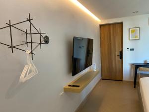 a living room with a tv on a wall at THE CELESTRAIL - Apartment - Check-In by Appointment Only - Non-hotel - Onnut BTS in Bangkok +17 photos