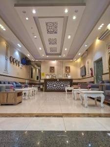 a waiting room with tables and chairs in a hospital at شقق البحر الأزرق المخدومه in Nimrān