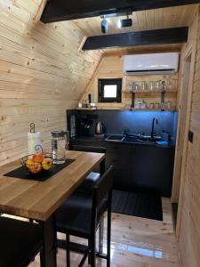 a kitchen with a wooden table with a bowl of fruit on it at Plivska vila 1 in Jajce