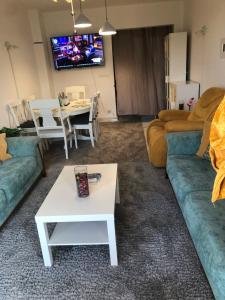 a living room with two couches and a table at Chilling home in Madinaty