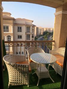 a patio with a table and chairs on a balcony at Chilling home in Madinaty