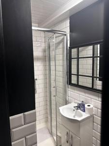 a white bathroom with a sink and a shower at Central City Living - Stylish & Spacious 5 Bedrooms in Parkside