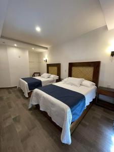 Postel nebo postele na pokoji v ubytování Gran Hotel Yacatas