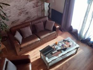 an overhead view of a living room with a couch at Charme du XVIIe siècle près de Nancy, jardin privé et sentiers balisés - FR-1-584-194 in Bouxières-aux-Chênes +19 photos