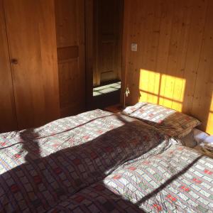 two beds sitting next to each other in a bedroom at Chalet Annika in Grimentz