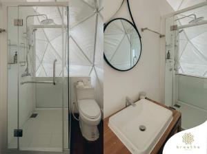 a bathroom with a shower and a toilet and a sink at Breathe Wild in Phumĭ Pu Rôdêt Leu