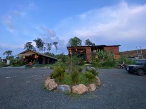 a house with a lot of plants in front of it at Breathe Wild in Phumĭ Pu Rôdêt Leu