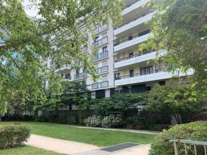 - un grand bâtiment blanc avec un parc en face dans l'établissement LE PARADIS - 2 chambres, balcon, parking, à Boulogne-Billancourt