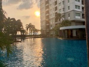 a large swimming pool in front of a building at Thamrin Residence City Home in Jakarta