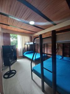 a room with two bunk beds and a television at Villa Montilla Cabañas Anapoima in Anapoima +27 photos