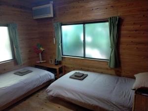 Giường trong phòng chung tại Slow Life Japan スローライフジャパン