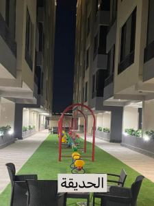 a playground in the middle of a building at night at شقة حديثة و موقع مميز in Dhahran +4 photos