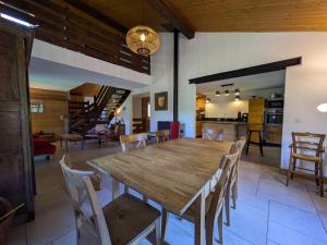 a dining room with a wooden table and chairs at Chalet rénové 12 pers, 5 ch, parking, poêle, sud-ouest - FR-1-342-321 in Beaufort