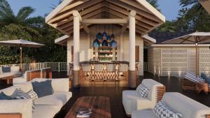 patio con mobili bianchi e gazebo. di Secrets Saint Lucia Resort & Spa - All Inclusive a Gros Islet