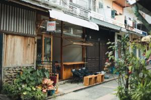 a shop with a sign on the side of a building at 1950 Luangprabang Hostel in Luang Prabang