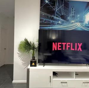 a tv screen with a netflix sign on a wall at Mahzan Private Room 3 in Truganina