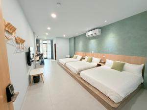Postel nebo postele na pokoji v ubytování 東港民宿 - 如你所院 Tourist Vacation B&B