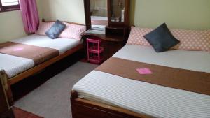 Кровать или кровати в номере Haranya Homestay
