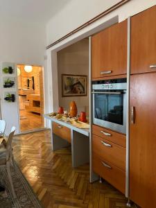a kitchen with wooden cabinets and a counter top at Apartment Leyla in Sarajevo