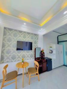 a living room with a table and a refrigerator at Apec Sunsea Homestay in Liên Trì (3) +8 photos