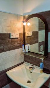 a bathroom with a sink and a mirror at Mirissa Green Villa in Mirissa
