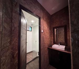 a bathroom with a sink and a mirror and a shower at Puncak Tawa Park in Tengahgirang