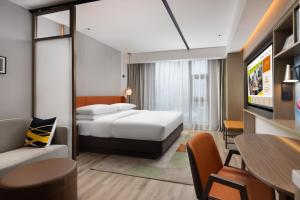 a hotel room with two beds and a table at Home2 Suites By Hilton Wuxi Huishan in Wuxi