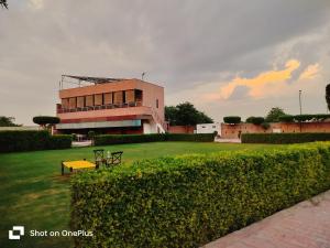 a building with a yellow bench in a yard at Apple Resort & Restaurant in Jodhpur