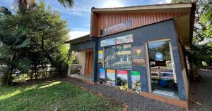 a building with a sign on the side of it at Hostel Rio do Boi in Praia Grande