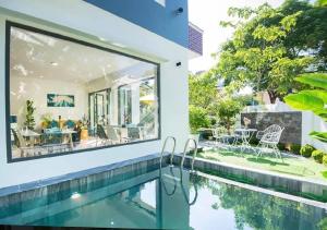 an image of a house with a swimming pool and a house at Hoi An Tháng 1 Villa in Hoi An