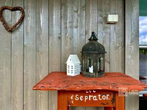a lantern on a table with a house on it at Modern cabin Skeikampen with ski-in out cross country trails & great view in Aulstad