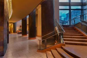 a lobby with a staircase in a building at The Westin Arlington in Arlington