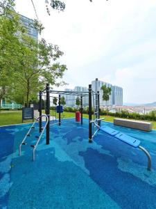 an empty playground in a park with blue at Southville Sensory Cozy 3 Bedroom w Hi-Speed Wi-Fi in Kampong Tangkas