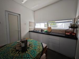 a small kitchen with a table and a window at Rumah Menik in Uluwatu