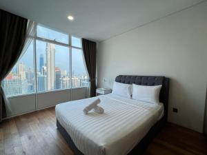 Voodi või voodid majutusasutuse Vortex Serviced Apartment KLCC By Elite Suites toas