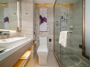 a bathroom with a toilet and a glass shower at Lavande Hotel Credit Building of Gaocheng District, Shijiazhuang City in Dongliucun