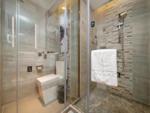 a bathroom with a shower and a toilet and a sink at Lavande Hotel Credit Building of Gaocheng District, Shijiazhuang City in Dongliucun