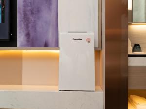 a white refrigerator sitting on a counter in a kitchen at Lavande Hotel Credit Building of Gaocheng District, Shijiazhuang City in Dongliucun