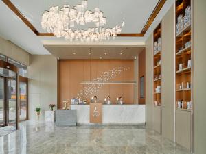 a lobby of a store with a reception desk and a chandelier at Lavande Hotel Credit Building of Gaocheng District, Shijiazhuang City in Dongliucun
