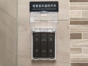 a electronic device is hanging on a wall at Lavande Hotel Credit Building of Gaocheng District, Shijiazhuang City in Dongliucun