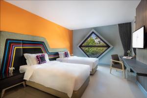 Voodi või voodid majutusasutuse Hotel Selene Chiang Rai toas