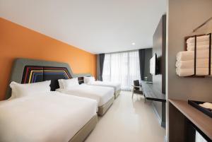 Voodi või voodid majutusasutuse Hotel Selene Chiang Rai toas