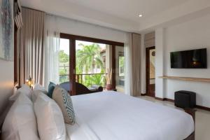 a bedroom with a white bed and a large window at 2 Secluded Villas Private Resort in Nathon Bay