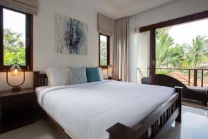 a bedroom with a large white bed and a balcony at 2 Secluded Villas Private Resort in Nathon Bay +76 photos